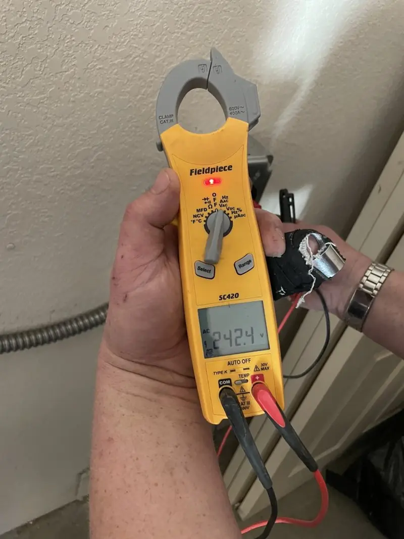 Voltage testing with clamp meter during Recessed Lighting Installation in Cambria